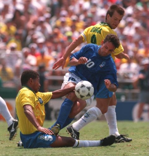 17 JUL 1994:  ROBERTO BAGGIO #10 OF ITALY IS TACKLED BY MAURO SILVA OF BRAZIL DURING THE BRAZIL VERSUS ITALY 1994 WORLD CUP FINAL AT THE ROSE BOWL STADIUM IN PASADENA, CALIFORNIA.  DUNGA, IN BACKGROUND LOOKS ON. Mandatory Credit: Billy Stickland/ALLSPORT