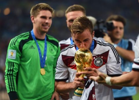 RIO DE JANEIRO, BRAZIL - JULY 13:  Mario Goetze of Germany kisses the World Cup trophy after defeating Argentina 1-0 in extra time during the 2014 FIFA World Cup Brazil Final match between Germany and Argentina at Maracana on July 13, 2014 in Rio de Janeiro, Brazil.  (Photo by Laurence Griffiths/Getty Images)