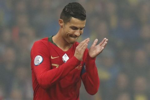 Portugal's Cristiano Ronaldo applauds during group B qualifying soccer match between Ukraine and Portugal at the Olympiyskiy stadium in Kyiv, Ukraine, Monday, Oct. 14, 2019. (AP Photo/Efrem Lukatsky)