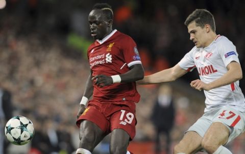 Liverpool's Sadio Mane, left, challenges for the ball with Spartak's Roman Zobnin during the Champions League Group E soccer match between Liverpool and Spartak Moscow at Anfield, Liverpool, England, Wednesday, Dec. 6, 2017. (AP Photo/Rui Vieira)