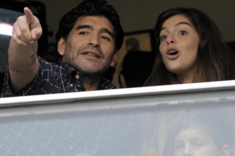 Argentina's national soccer team coach Diego Maradona, left, talks to his daughter Dalma during the Argentinean league soccer match between Boca Juniors and Racing in Buenos Aires, Sunday, Nov. 30, 2008. (AP Photo/Daniel Luna)