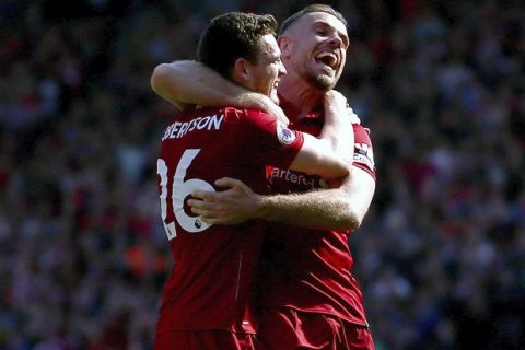 Liverpool's Andrew Robertson, left, celebrates scoring his side's fourth goal of the game with teammate Jordan Henderson during their English Premier League soccer match against Brighton & Hove Albion at Anfield, Liverpool, England, Sunday, May 13, 2018. (Dave Thompson/PA via AP)