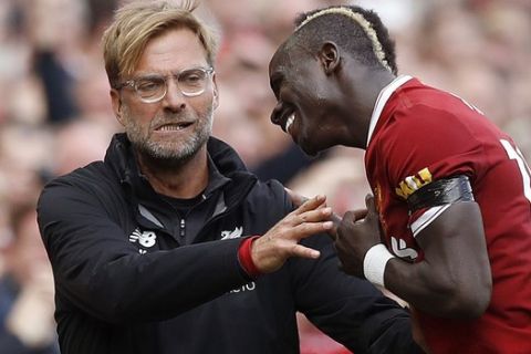 Liverpool's Sadio Mane, right, celebrates his goal with manager Jurgen Klopp, during the English Premier League soccer match between Liverpool and Crystal Palace, at Anfield, in Liverpool, England, Saturday Aug. 19, 2017. (Martin Rickett/PA via AP)