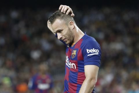 Barcelona's Arthur touches his head during the Spanish La Liga soccer match between FC Barcelona and Villarreal CF at the Camp Nou stadium in Barcelona, Spain, Tuesday, Sep. 24, 2019. (AP Photo/Joan Monfort)