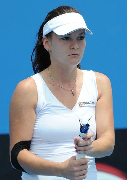 Agnieszka Radwanska of Poland contemplates her broken racquet during her first round women's singles match against Kimiko Date-Krumm of Japan on the second day of the Australian Open tennis tournament in Melbourne on January 18, 2011.   Radwanska won 6-4, 4-6, 7-5.      IMAGE STRICTLY RESTRICTED TO EDITORIAL USE        STRICTLY NO COMMERCIAL USE      AFP PHOTO/Torsten BLACKWOOD (Photo credit should read TORSTEN BLACKWOOD/AFP/Getty Images)