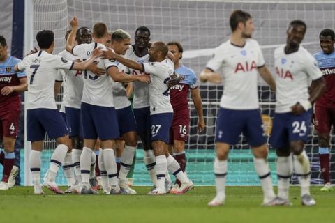 Tottenham players celebrate their opening goal during the English Premier League soccer match between Tottenham Hotspur and West Ham at the Tottenham Hotspur stadium in London, England, Tuesday, June 23, 2020. (AP photo/Kirsty Wigglesworth, Pool)