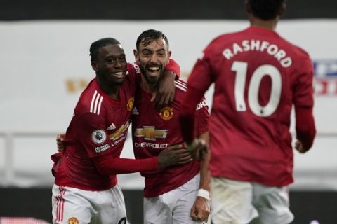 Manchester United's Bruno Fernandes, centre, celebrates his goal during the English Premier League soccer match between Newcastle United and Manchester United at St. James' Park in Newcastle, England, Saturday, Oct. 17, 2020. (Owen Humphreys/PA via AP)