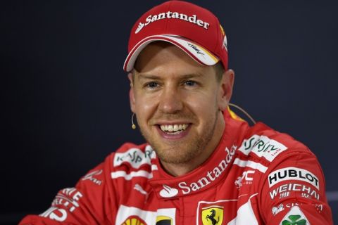 Ferrari driver Sebastian Vettel of Germany smiles at a press conference following his second place finish in qualifying for the Australian Formula One Grand Prix in Melbourne, Australia, Saturday, March 25, 2017. (AP Photo/Andy Brownbill)
