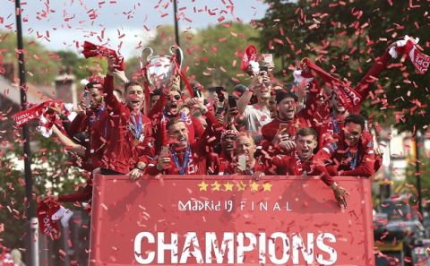 Liverpool soccer team ride an open top bus during the Champions League Cup Winners Parade through the streets of Liverpool, England, Sunday June 2, 2019.  Liverpool is champion of Europe for a sixth time after beating Tottenham 2-0 in the Champions League final played in Madrid Saturday. (Barrington Coombs/PA via AP)