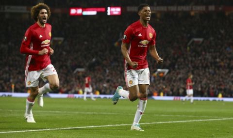 Manchester United's Marcus Rashford, right, celebrates scoring his side's second goal chased by his teammate Marouane Fellaini during the Europa League quarterfinal second leg soccer match between Manchester United and Anderlecht at Old Trafford stadium, in Manchester, England, Thursday, April 20, 2017. (AP Photo/Dave Thompson)