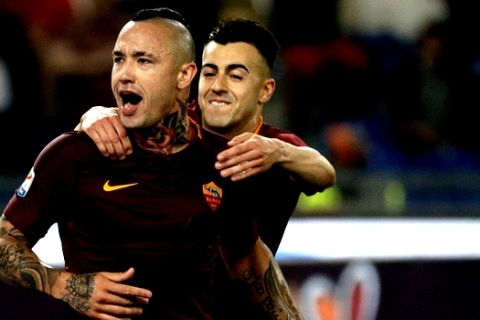 Roma's Radja Nainggolan, left, celebrates with his teammate Stephan El Shaarawi after scoring his side's third goal during a Serie A soccer match between Roma and Juventus, at Rome's Olympic stadium, Sunday, May 14, 2017. (AP Photo/Gregorio Borgia)