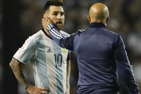 Argentina's Lionel Messi, left, is comforted by Argentina coach Jorge Sampaoli after a World Cup qualifying soccer match at La Bombonera stadium in Buenos Aires, Argentina, Thursday, Oct. 5, 2017. Argentina tied the match 0-0 and is almost eliminated from the upcoming World Cup in Russia. (AP Photo/Victor R. Caivano)
