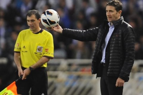 Real Sociedad's Philippe Montanier from France, right, holds the ball during their Spanish League soccer match against Real Madrid, at Anoeta stadium in San Sebastian, northern Spain, Sunday, May 26, 2013. (AP Photo/Alvaro Barrientos)