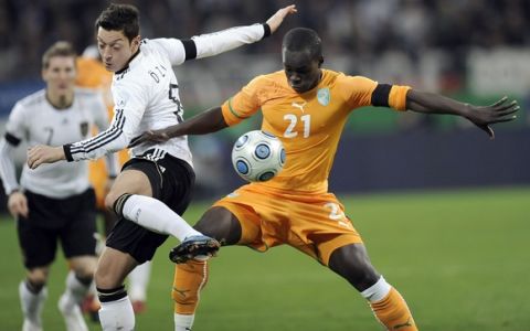 Ivory Coast's Cheik Tiote, right, and Germany's Mesut Oezil challenge for the ball during the friendly soccer match between Germany and Ivory Coast in Gelsenkirchen, Germany, Wednesday, Nov. 18, 2009. (AP Photo/Martin Meissner)