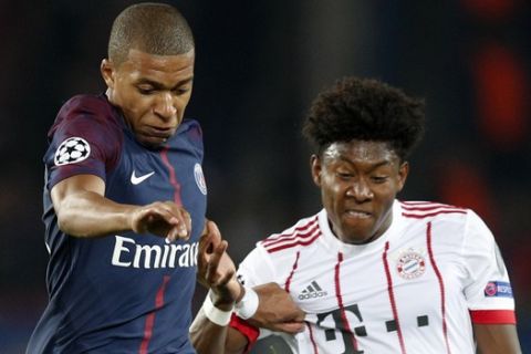 PSG's Kylian Mbappe, left, and Bayern's David Alaba vie for the ball during a Champions League Group B soccer match between Paris Saint-Germain and Bayern Munich at the Parc des Princes stadium in Paris, France, Wednesday, Sept. 27, 2017. (AP Photo/Christophe Ena)
