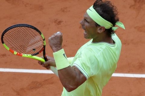 Spain's Rafael Nadal clenches his fist after scoring a point against Switzerland's Roger Federer during their semifinal match of the French Open tennis tournament at the Roland Garros stadium in Paris, Friday, June 7, 2019. (AP Photo/Pavel Golovkin)