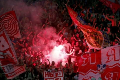 Red Star fans celebrate at the end of the Champions League play-off, second leg soccer match between Red Star and Young Boys on the stadium Rajko Mitic in Belgrade, Serbia, Tuesday, Aug. 27, 2019. (AP Photo/Darko Vojinovic)