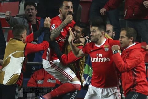Benfica's Kostas Mitroglou celebrates with teammates scoring the opening goal during the Champions League round of 16, first leg, soccer match between Benfica and Borussia Dortmund at the Luz stadium in Lisbon, Tuesday, Feb. 14, 2017. (AP Photo/Armando Franca)