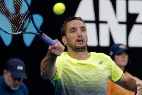 Serbia's Viktor Troicki makes a forehand return to Australia's Nick Kyrgios during their second round match at the Australian Open tennis championships in Melbourne, Australia, Wednesday, Jan. 17, 2018. (AP Photo/Vincent Thian)