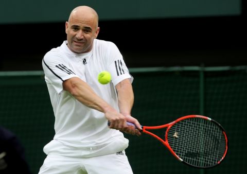 LONDON, ENGLAND - MAY 17:  Andre Agassi hits a backhand during the Mens Singles match against Tim Henman during the "Centre Court Celebration" at Wimbledon on May 17, 2009 in London, England.  (Photo by Hamish Blair/Getty Images)