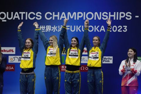 Australian team celebrates during medal ceremony after making world record in Women 4 x100 meter freestyle relay finals at the World Swimming Championships in Fukuoka, Japan, Sunday, July 23, 2023. (AP Photo/Lee Jin-man)