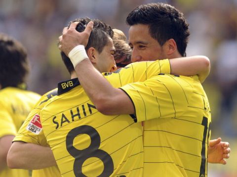 RESTRICTIONS / EMBARGO - ONLINE CLIENTS MAY USE UP TO SIX IMAGES DURING EACH MATCH WITHOUT THE AUTHORISATION OF THE DFL. NO MOBILE USE DURING THE MATCH AND FOR A FURTHER TWO HOURS AFTERWARDS IS PERMITTED WITHOUT THE AUTHORISATION OF THE DFL.Dortmund's Lukas Barrios (L) and Nuri Sahin celebrates scoring during the German first division Bundesliga football match Borussia Dortmund v Hanover 96 in the western German city of Dortmund on April 2, 2011. Dortmund won the match 4-1. AFP PHOTO / PATRIK STOLLARZ (Photo credit should read PATRIK STOLLARZ/AFP/Getty Images)