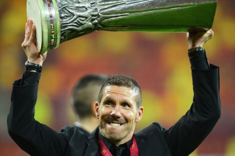 BUCHAREST, ROMANIA - MAY 09:  Atletico Madrid Coach Diego Simeone holds the trophy aloft at the end of the UEFA Europa League Final between Atletico Madrid and Athletic Bilbao at the National Arena on May 9, 2012 in Bucharest, Romania.  (Photo by Shaun Botterill/Getty Images)
