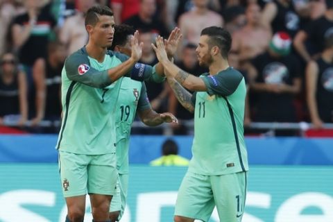 Portugal's Cristiano Ronaldo, left, and Vieirinha celebrate their sides first goal during the Euro 2016 Group F soccer match between Hungary and Portugal at the Grand Stade in Decines-­Charpieu, near Lyon, France, Wednesday, June 22, 2016. (AP Photo/Darko Bandic)