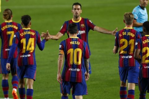 Barcelona's Lionel Messi celebrates with team mates after scoring his side's 3rd goal during the Spanish La Liga soccer match between FC Barcelona and Villareal FC at the Camp Nou stadium in Barcelona, Spain, Sunday, Sept. 27, 2020. (AP Photo/Joan Monfort)