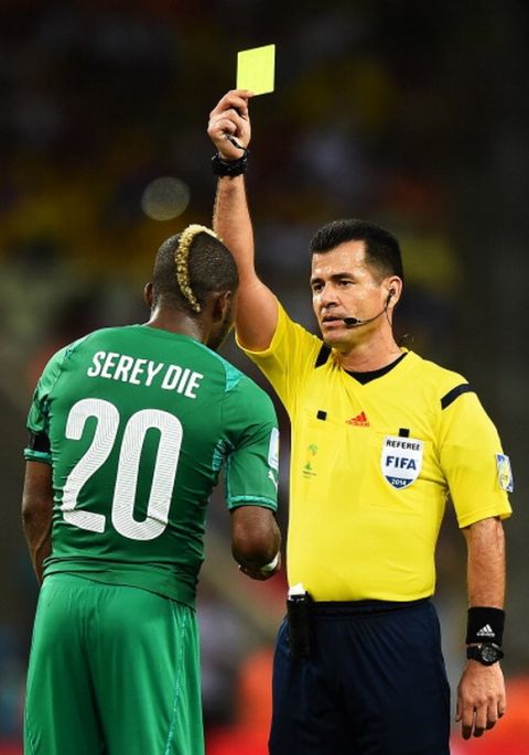 FORTALEZA, BRAZIL - JUNE 24: Die Serey of the Ivory Coast is shown a yellow card by referee Carlos Vera during the 2014 FIFA World Cup Brazil Group C match between Greece and the Ivory Coast at Castelao on June 24, 2014 in Fortaleza, Brazil.  (Photo by Laurence Griffiths/Getty Images)