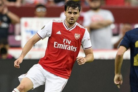 Arsenal defender Carl Jenkinson, left, controls the ball against Real Madrid midfielder Isco (22) during the second half of an International Champions Cup soccer match, Tuesday, July 23, 2019, in Landover, Md. The game ended 2-2 and Real Madrid won 3-2 after penalty kicks. (AP Photo/Nick Wass)