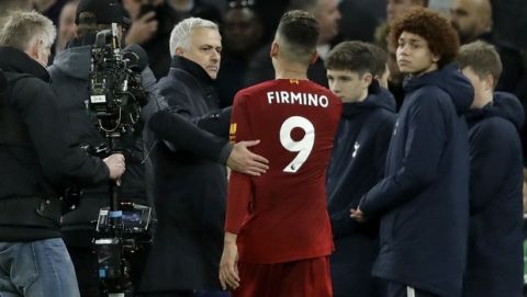 Tottenham's manager Jose Mourinho talks to Liverpool's Roberto Firmino at the end of the English Premier League soccer match between Tottenham Hotspur and Liverpool at the Tottenham Hotspur Stadium in London, England, Saturday, Jan. 11, 2020. Firmino scored the goal in Liverpool's 1-0 win. (AP Photo/Matt Dunham)