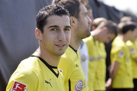 Dortmund's new player Henrikh Mkhitaryan from Armenia  waits  during a media  event  of  Borussia Dortmund for the new Bundesliga  soccer season in Dortmund, Germany, Tuesday, July 9, 2013. Borussia Dortmund completed the signing of Armenia midfielder Henrikh Mkhitaryan from Shakhtar Donetsk in a club record deal on Tuesday. Both clubs announced the transfer on their websites, with the Ukrainian side saying the fee for the 24-year-old Mkhitaryan is 27.5 million euros (US $35.4 million).  (AP Photo/Martin Meissner)