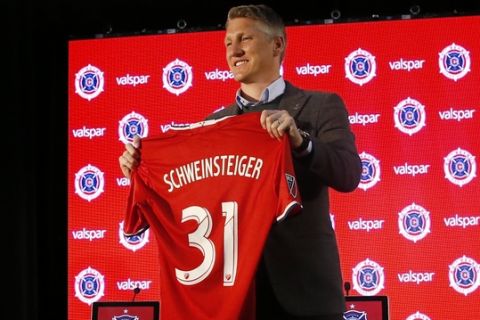 The Chicago Fire's new player Basitan Schweinsteiger holds his jersey during a press conference at the The PrivateBank Fire Pitch in Chicago, Wednesday, March 29, 2017. (AP Photo/Nam Y. Huh)