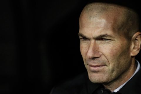 Real Madrid's head coach Zinedine Zidane sits on the bench during a Spanish Copa del Rey soccer match between Real Madrid and Real Sociedad at the Santiago Bernabeu stadium in Madrid, Spain, Thursday, Feb. 6, 2020. (AP Photo/Manu Fernandez)