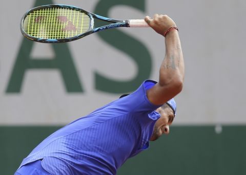 Australia's Nick Kyrgios breaks his racket in his second round match against South Africa's Kevin Anderson at the French Open tennis tournament at the Roland Garros stadium, in Paris, France. Thursday, June 1, 2017. (AP Photo/David Vincent)