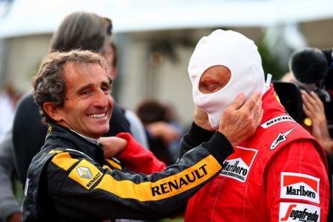 SPIELBERG, AUSTRIA - JUNE 20:  Former driver Alain Prost helps Niki Lauda prepare on track after qualifying for the Formula One Grand Prix of Austria at Red Bull Ring on June 20, 2015 in Spielberg, Austria.  (Photo by Mark Thompson/Getty Images)