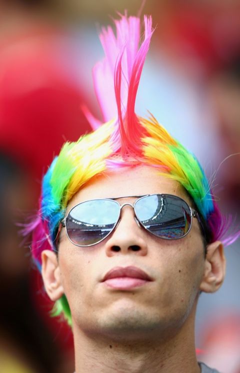 SALVADOR, BRAZIL - JUNE 13: A fan looks on while wearing a colorful mohawk wig before the 2014 FIFA World Cup Brazil Group B match between Spain and Netherlands at Arena Fonte Nova on June 13, 2014 in Salvador, Brazil.  (Photo by Ian Walton/Getty Images)