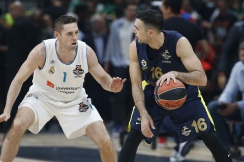 Fenerbahce's Kostas Sloukas dribbles the ball as Real Madrid's Fabien Causeur guards him during their Final Four Euroleague final basketball match between Real Madrid and Fenerbahce in Belgrade, Serbia, Sunday, May 20, 2018. (AP Photo/Darko Vojinovic)