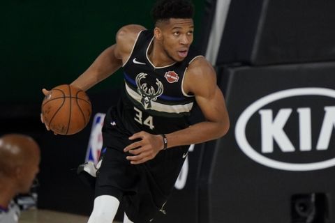 Milwaukee Bucks' Giannis Antetokounmpo (34) dribbles against the Miami Heat during the second half of an NBA conference semifinal playoff basketball game Wednesday, Sept. 2, 2020, in Lake Buena Vista, Fla. (AP Photo/Mark J. Terrill)
