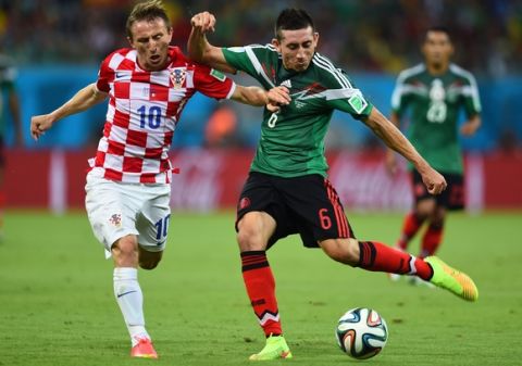 RECIFE, BRAZIL - JUNE 23:  Luka Modric of Croatia and Hector Herrera of Mexico compete for the ball during the 2014 FIFA World Cup Brazil Group A match between Croatia and Mexico at Arena Pernambuco on June 23, 2014 in Recife, Brazil.  (Photo by Jamie McDonald/Getty Images)