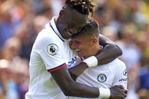 Chelsea's Mason Mount, right, celebrates scoring his side's second goal of the game with Tammy Abraham during the English Premier League soccer match between Norwich City and Chelsea at the Carrow Road Stadium, Norwich, England. Saturday, Aug, 24 2019. (Joe Giddens/PA via AP)