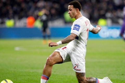 FILE - In tis file photo dated Sunday, April 1, 2018, Lyon's Memphis Depay controls the ball during a French League One soccer match against Toulouse in Decines, near Lyon, central France. After being moved from a wide left position into a central strikers role, the notoriously erratic Depay seems to have hit top form for the last games of the 2018 season. (AP Photo/Laurent Cipriani, FILE)