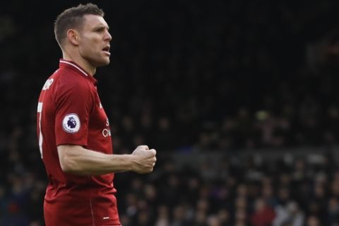 Liverpool's James Milner celebrates after scoring his side's second goal, during the English Premier League soccer match between Fulham and Liverpool at Craven Cottage stadium in London, Sunday, March 17, 2019. (AP Photo/Kirsty Wigglesworth)