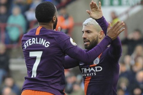 Manchester City's Raheem Sterling, left, celebrates teammate Sergio Aguero, after scoring the second goal for his team, during the English Premier League soccer match between Huddersfield Town and Manchester City at John Smith's stadium in Huddersfield, England, Sunday, Jan. 20, 2019. (AP Photo/Rui Vieira)