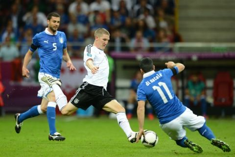 German midfielder Bastian Schweinsteiger vies with Italian forward Antonio Di Natale (R0 during the Euro 2012 football championships semi-final match Germany vs Italy on June 28, 2012 at the National Stadium in Warsaw.  AFP PHOTO / FRANCISCO LEONG        (Photo credit should read FRANCISCO LEONG/AFP/GettyImages)