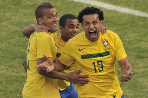 Brazilian forward Fred (R) celebrates with teammates Daniel Alves (L) and Lucas Moura, after scoring against Paraguay, during their 2011 Copa America Group B first round football match, at the Mario Kempes stadium in Cordoba, 770 Km northwest of Buenos Aires, on July 9, 2011. The match ended 2-2.     AFP PHOTO / OMAR TORRES (Photo credit should read OMAR TORRES/AFP/Getty Images)