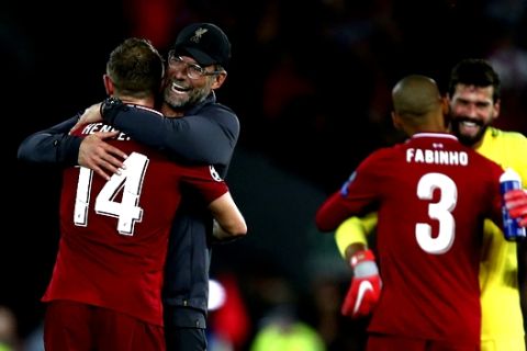 Liverpool's coach Juergen Klopp hugs Liverpool's Jordan Henderson after the Champions League Group C soccer match between Liverpool and Paris-Saint-Germain at Anfield stadium in Liverpool, England, Tuesday, Sept. 18, 2018. Liverpool won the match 3-2. (AP Photo/Dave Thompson)