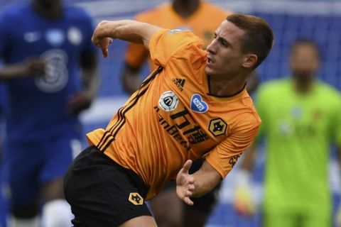 Wolverhampton Wanderers' Daniel Podence, right, challenges Chelsea's Mateo Kovacic during the English Premier League soccer match between Chelsea and Wolverhampton Wanderers at Stamford Bridge, in London, Sunday July 26, 2020. (Daniel Leal-Olivas/Pool via AP)
