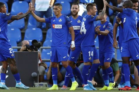 Getafe's players celebrate after scoring their side's first goal during Europe League Group C soccer match between Getafe and Trabzonspor at the Alfonso Perez stadium in Getafe, Spain, Thursday, Sept. 19, 2019. (AP Photo/Manu Fernandez)